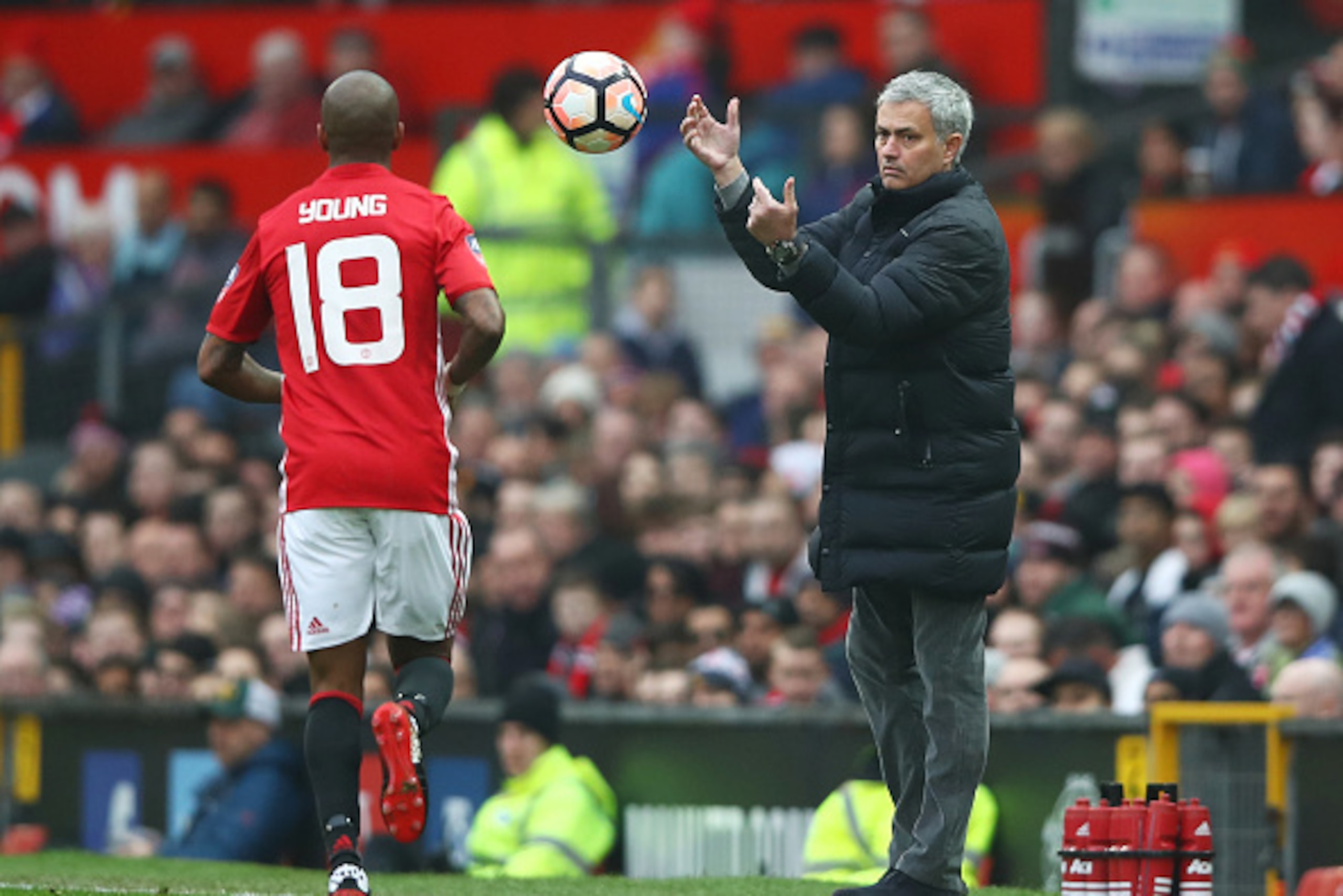 MANCHESTER, ENGLAND - JANUARY 07:  Jose Mourinho, Manager of Manchester United throws the ball to Ashley Young of Manchester United during the Emirates FA Cup third round match between Manchester United and Reading at Old Trafford on January 7, 2017 in Ma
