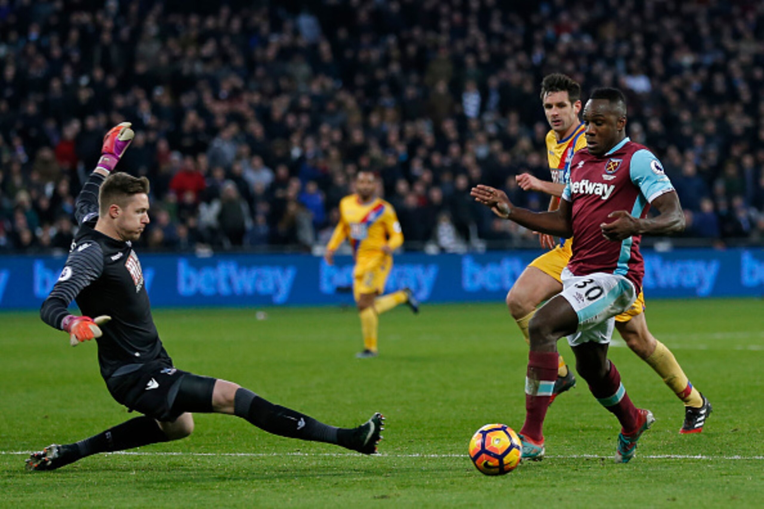 West Ham United's English midfielder Michail Antonio (R) goes around Crystal Palace's Welsh goalkeeper Wayne Hennessey (L) in the build up to their first goal during the English Premier League football match between West Ham United and Crystal Palace at T