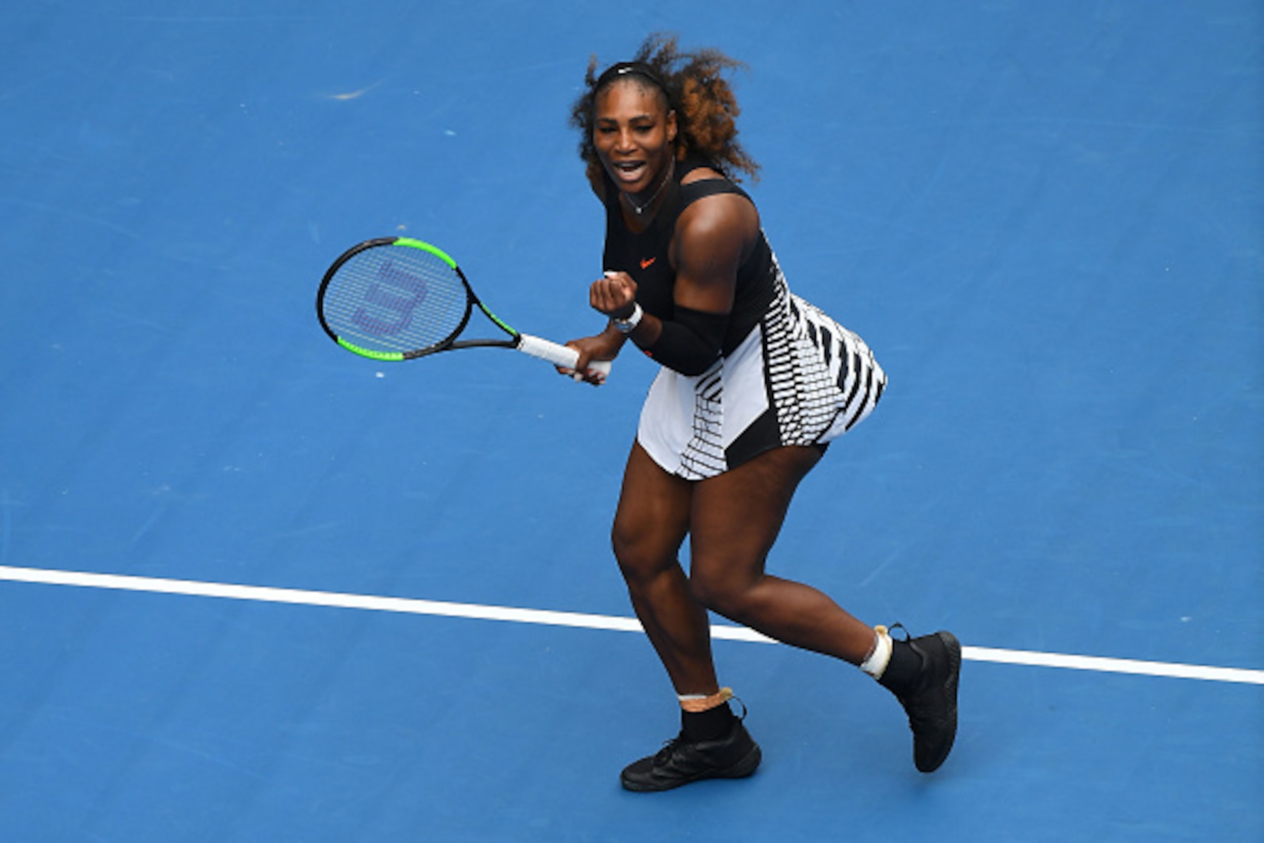 MELBOURNE, AUSTRALIA - JANUARY 17:  Serena Williams of the United States celebrates winning her first round match against Belinda Bencic of Switzerland on day two of the 2017 Australian Open at Melbourne Park on January 17, 2017 in Melbourne, Australia.  