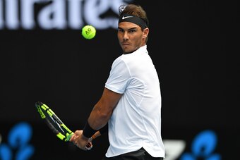 Spain's Rafael Nadal hits a return against Germany's Florian Mayer during their men's singles match on day two of the Australian Open tennis tournament in Melbourne on January 17, 2017. / AFP / GREG WOOD / IMAGE RESTRICTED TO EDITORIAL USE - STRICTLY NO C