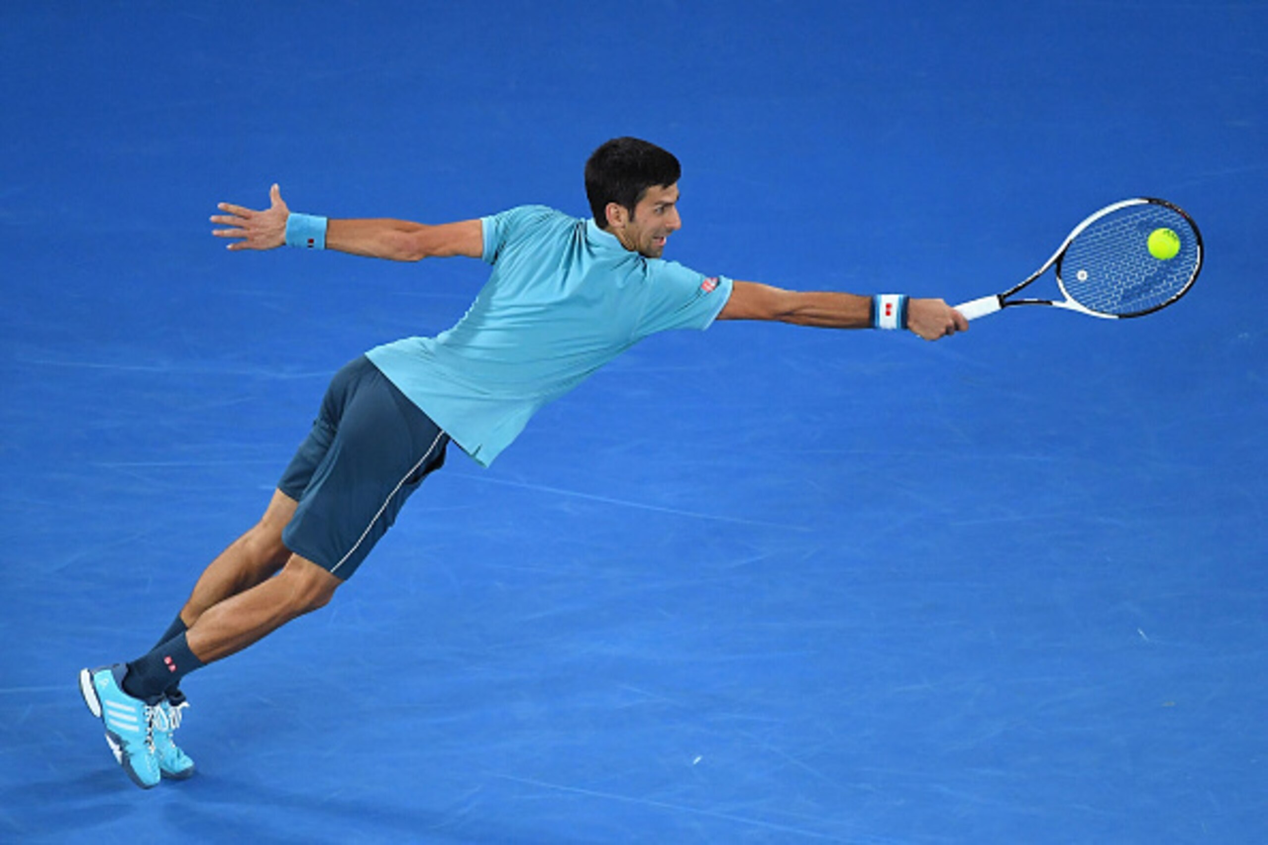 MELBOURNE, AUSTRALIA - JANUARY 17:  Novak Djokovic of Serbia plays a backhand in his first round match against Fernando Verdasco of Spain  on day two of the 2017 Australian Open at Melbourne Park on January 17, 2017 in Melbourne, Australia.  (Photo by Qui