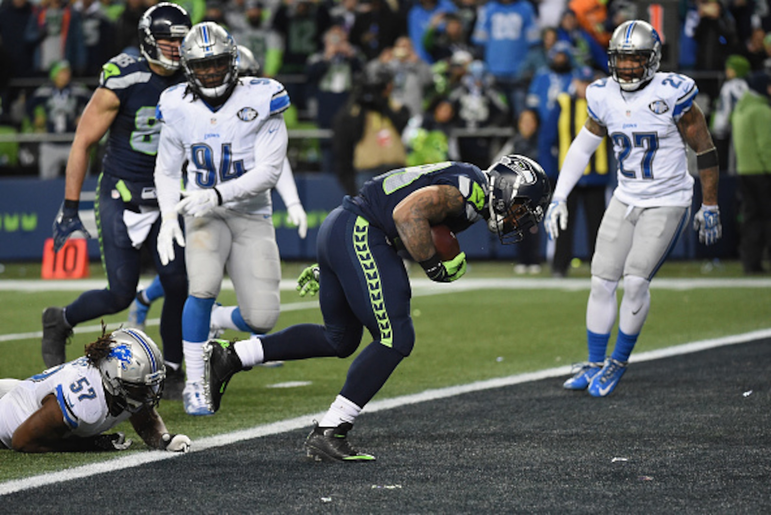 SEATTLE, WA - JANUARY 07:  Thomas Rawls #34 of the Seattle Seahawks scores a 4-yard touchdown during the fourth quarter against the Detroit Lions in the NFC Wild Card game at CenturyLink Field on January 7, 2017 in Seattle, Washington.  (Photo by Steve Dy