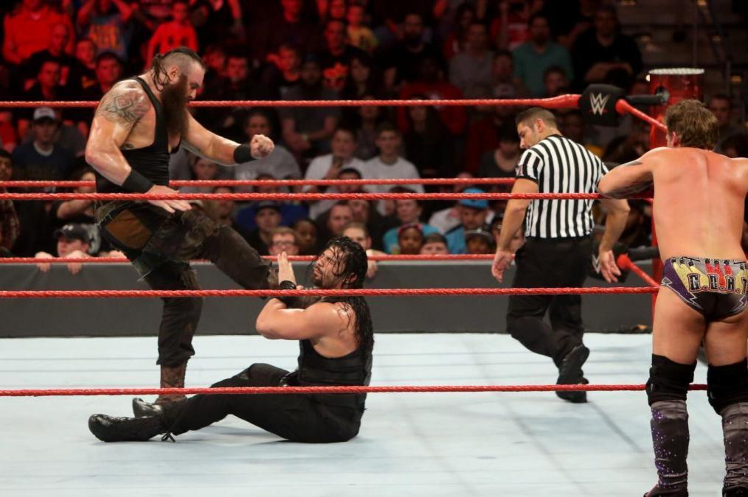 Braun Strowman kicks Roman Reigns during six-man tag team action on Monday's Raw.