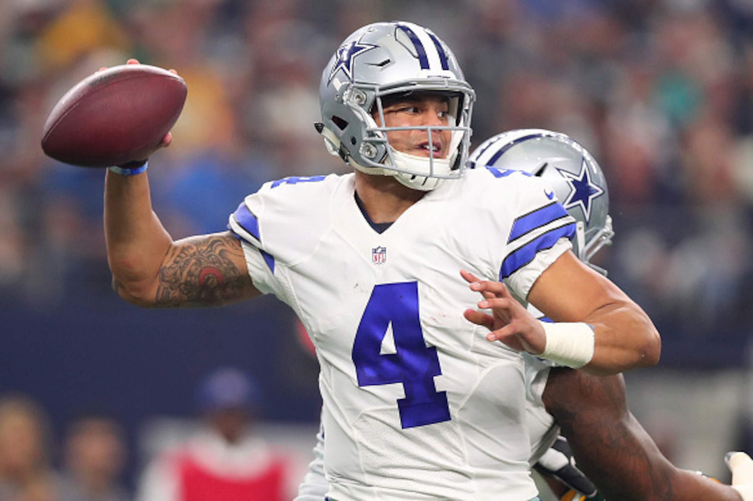 ARLINGTON, TX - JANUARY 15:  Dak Prescott #4 of the Dallas Cowboys drops back to pass during the second quarter against the Green Bay Packers in the NFC Divisional Playoff game at AT&T Stadium on January 15, 2017 in Arlington, Texas.  (Photo by Tom Pennin