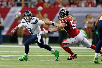 ATLANTA, GA - JANUARY 14:   Brooks Reed #50 of the Atlanta Falcons trys to tackle  Russell Wilson #3 of the Seattle Seahawks at the Georgia Dome on January 14, 2017 in Atlanta, Georgia.  (Photo by Kevin C. Cox/Getty Images)