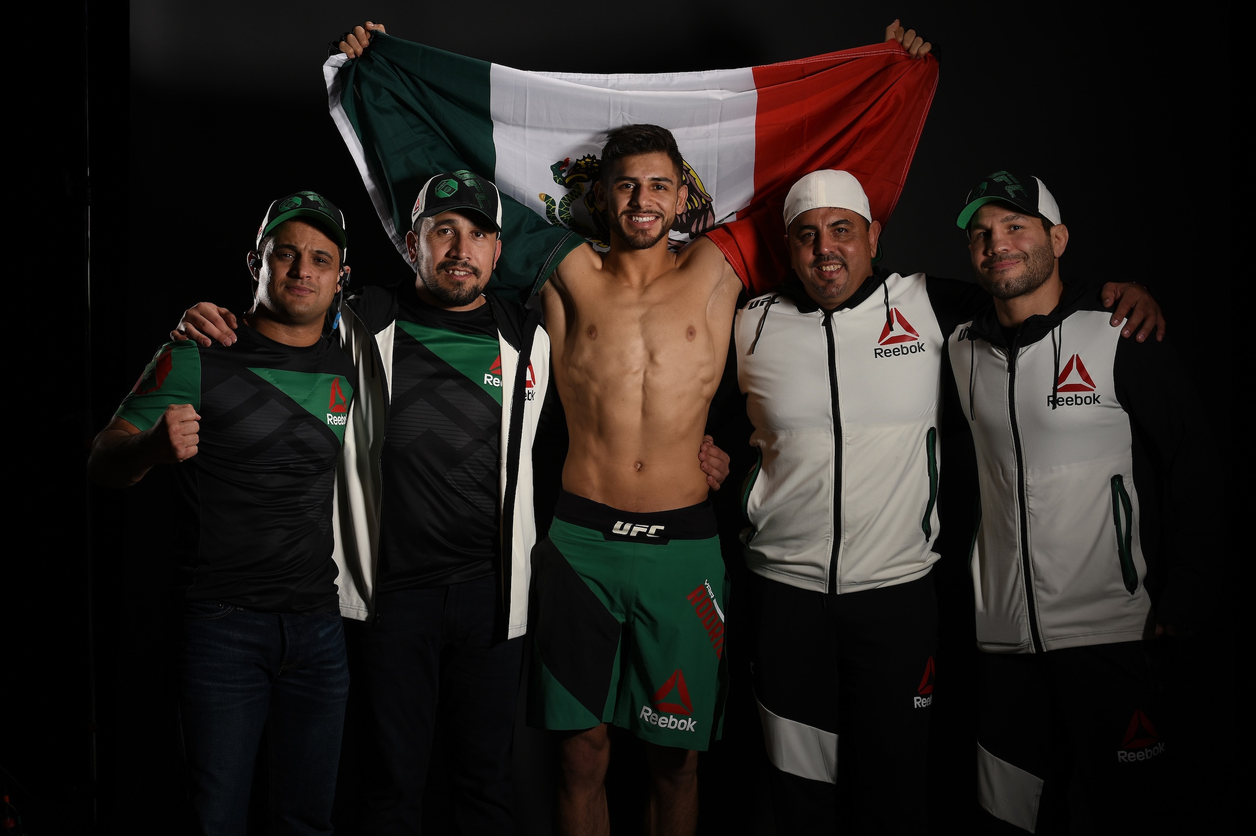 PHOENIX, AZ - JANUARY 15:  Yair Rodriguez of Mexico poses for a post fight portrait with his team backstage during the UFC Fight Night event inside Talking Stick Resort Arena on January 15, 2017 in Phoenix, Arizona. (Photo by Mike Roach/Zuffa LLC/Zuffa LL