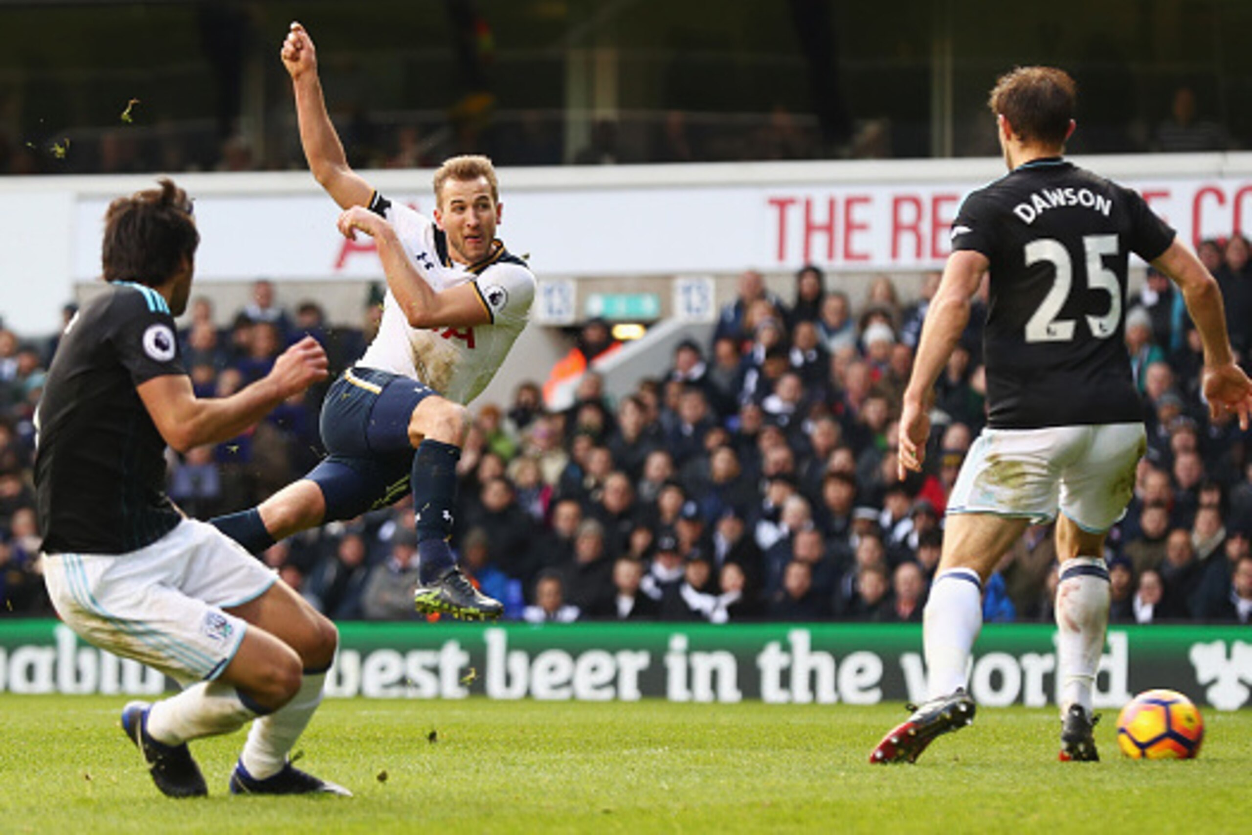 LONDON, ENGLAND - JANUARY 14: Harry Kane of Tottenham Hotspur (L) scores his sides third goal during the Premier League match between Tottenham Hotspur and West Bromwich Albion at White Hart Lane on January 14, 2017 in London, England.  (Photo by Clive Ro