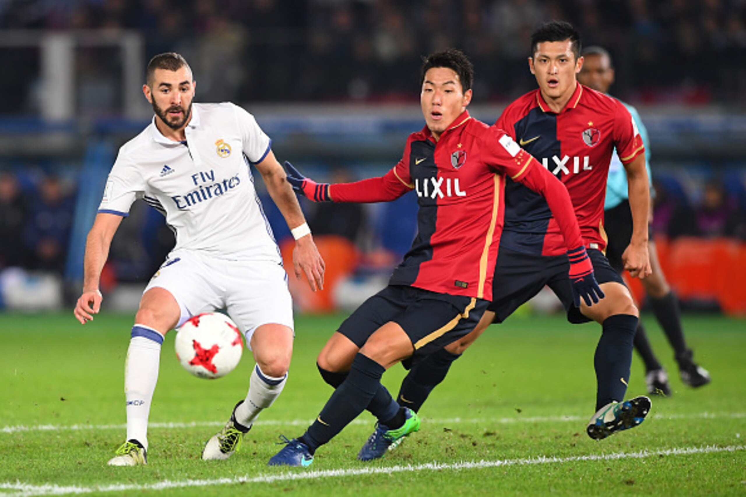 YOKOHAMA, JAPAN - DECEMBER 18:  Gen Shoji of Kashima Antlers and Karim Benzema of Real Madrid compete for the ball during the FIFA Club World Cup final match between Real Madrid and Kashima Antlers at International Stadium Yokohama on December 18, 2016 in