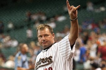 HOUSTON,TX - SEPTEMBER 22:  Former Houston Astros pitcher Roger Clemens gives a 'Hook'em Horns' sign to the crowd during a pre-game ceremony saluting the Houston Astros'  All-Time 25-Man Roster at Minute Maid Park on September 22, 2012 in Houston, Texas. 