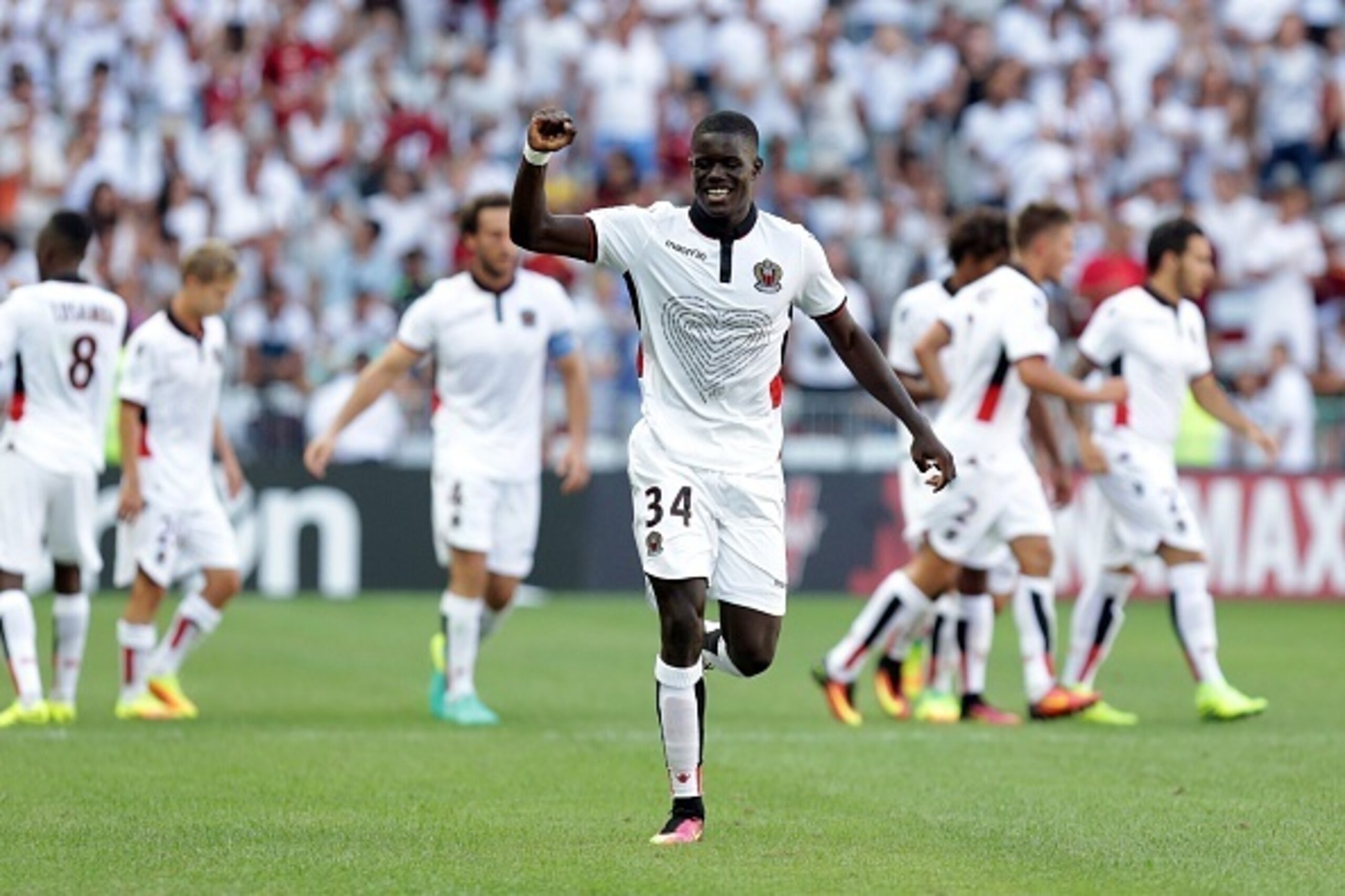 Nice's French defender Malang Sarr celebrates with teammates after scoring a goal during the French L1 football match between Nice and Rennes on August 14, 2016, at the Allianz Riviera stadium in Nice, southeastern France.  / AFP / JEAN CHRISTOPHE MAGNENE