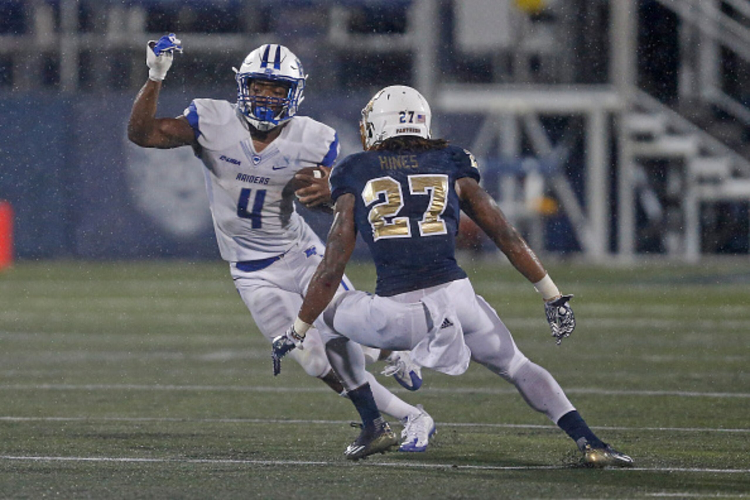 MIAMI, FL - OCTOBER 29: Xavier Hines #27 of the Florida International Golden Panthers defense against I'Tavius Mathers #4 of the Middle Tennessee Blue Raiders as h runs with the ball on October 29, 2016 at FIU Stadium in Miami, Florida. Middle Tennessee d MIAMI, FL - OCTOBER 29: Xavier Hines #27 of the Florida International Golden Panthers defense against I'Tavius Mathers #4 of the Middle Tennessee Blue Raiders as h runs with the ball on October 29, 2016 at FIU Stadium in Miami, Florida. Middle Tennessee d