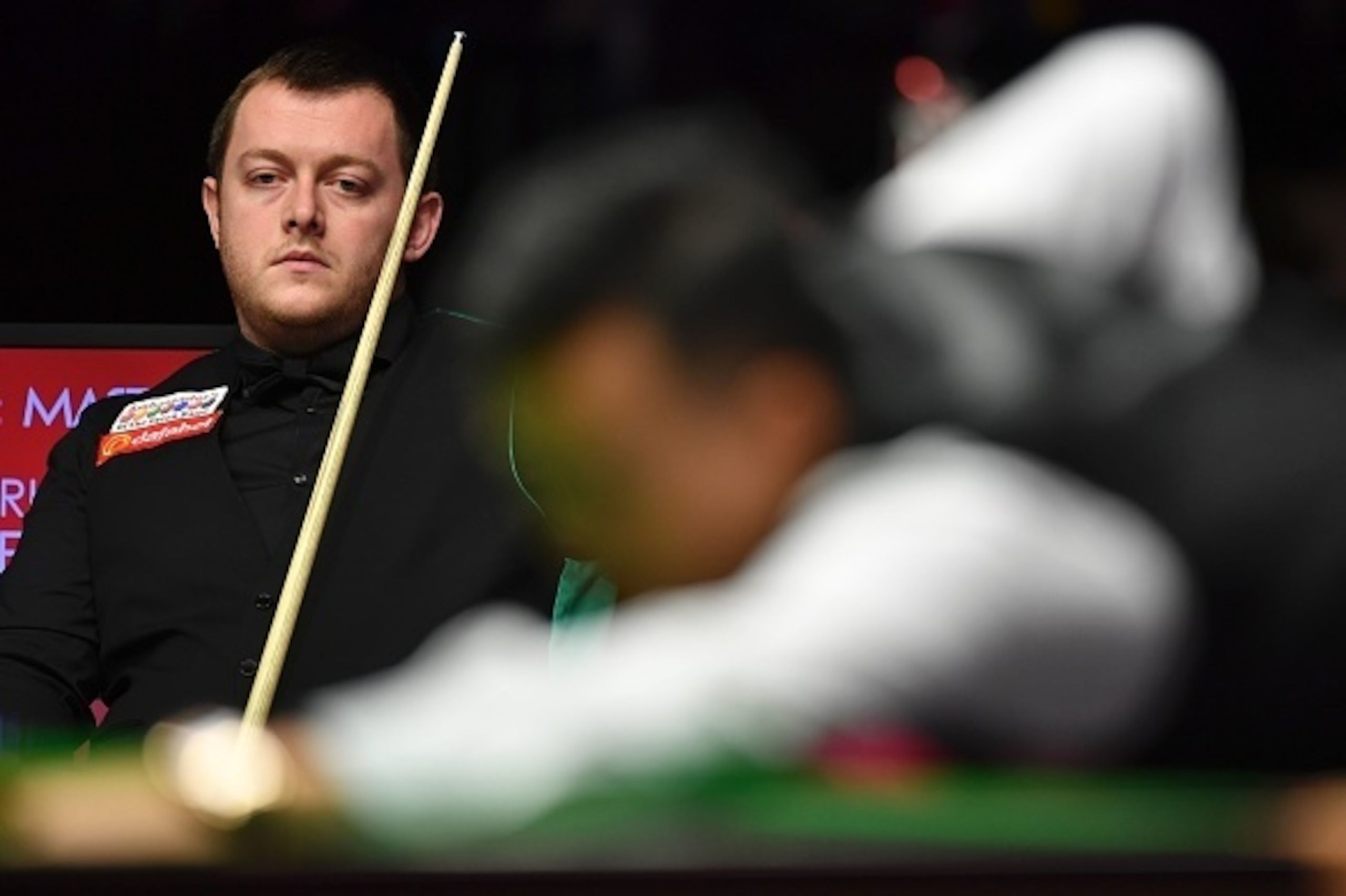 Northern Ireland's Mark Allen watches as Hong Kong snooker player Marco Fu plays a shot during their quarter-final match during the Masters Snooker tournament at Alexandra Palace in London, on January 19, 2017. / AFP / Ben STANSALL        (Photo credit sh
