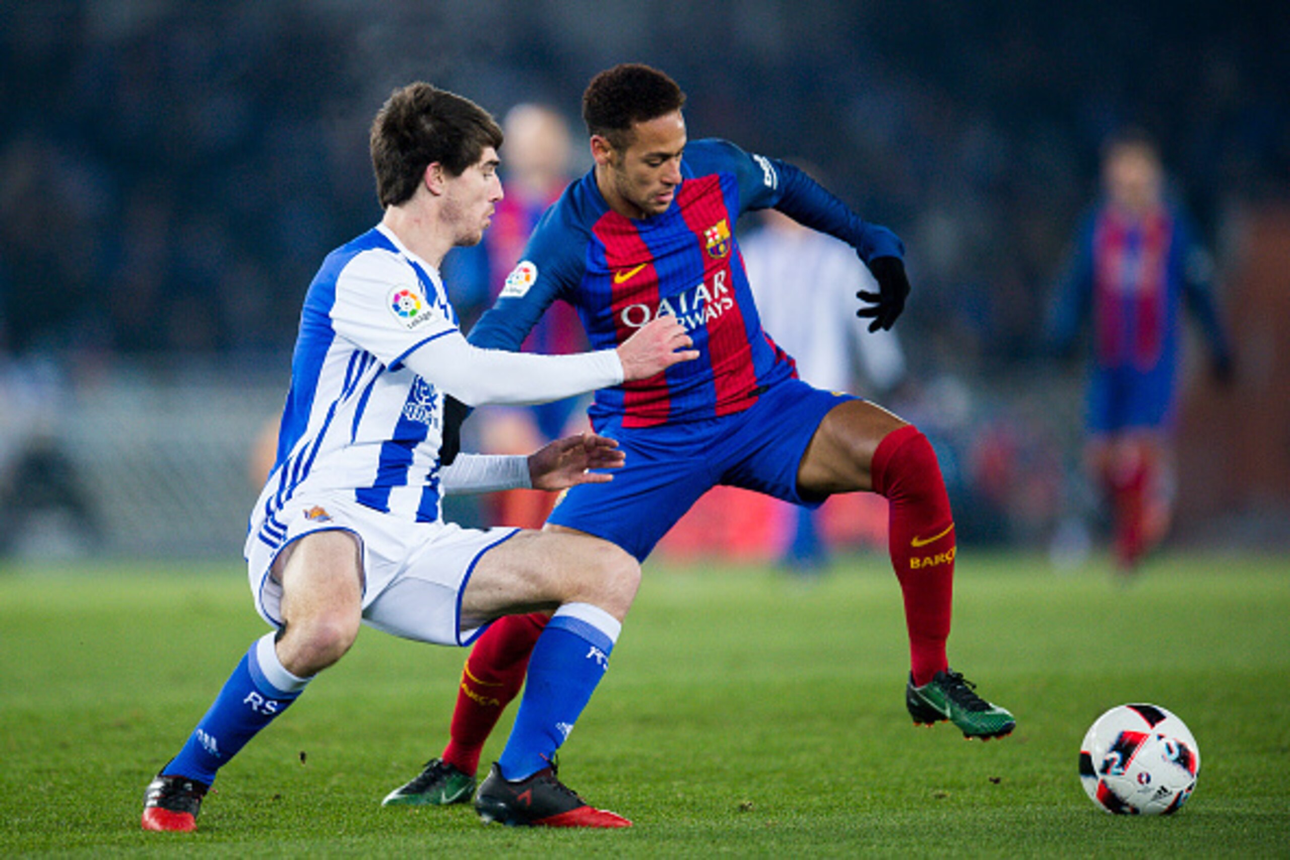 SAN SEBASTIAN, SPAIN - JANUARY 19:  Neymar Jr. of FC Barcelona duels for the ball with Aritz Elustondo of Real Sociedad during the Copa del Rey Quarter Final, First Leg match between Real Sociedad de Futbol and FC Barcelona at Estadio Anoeta on January 19