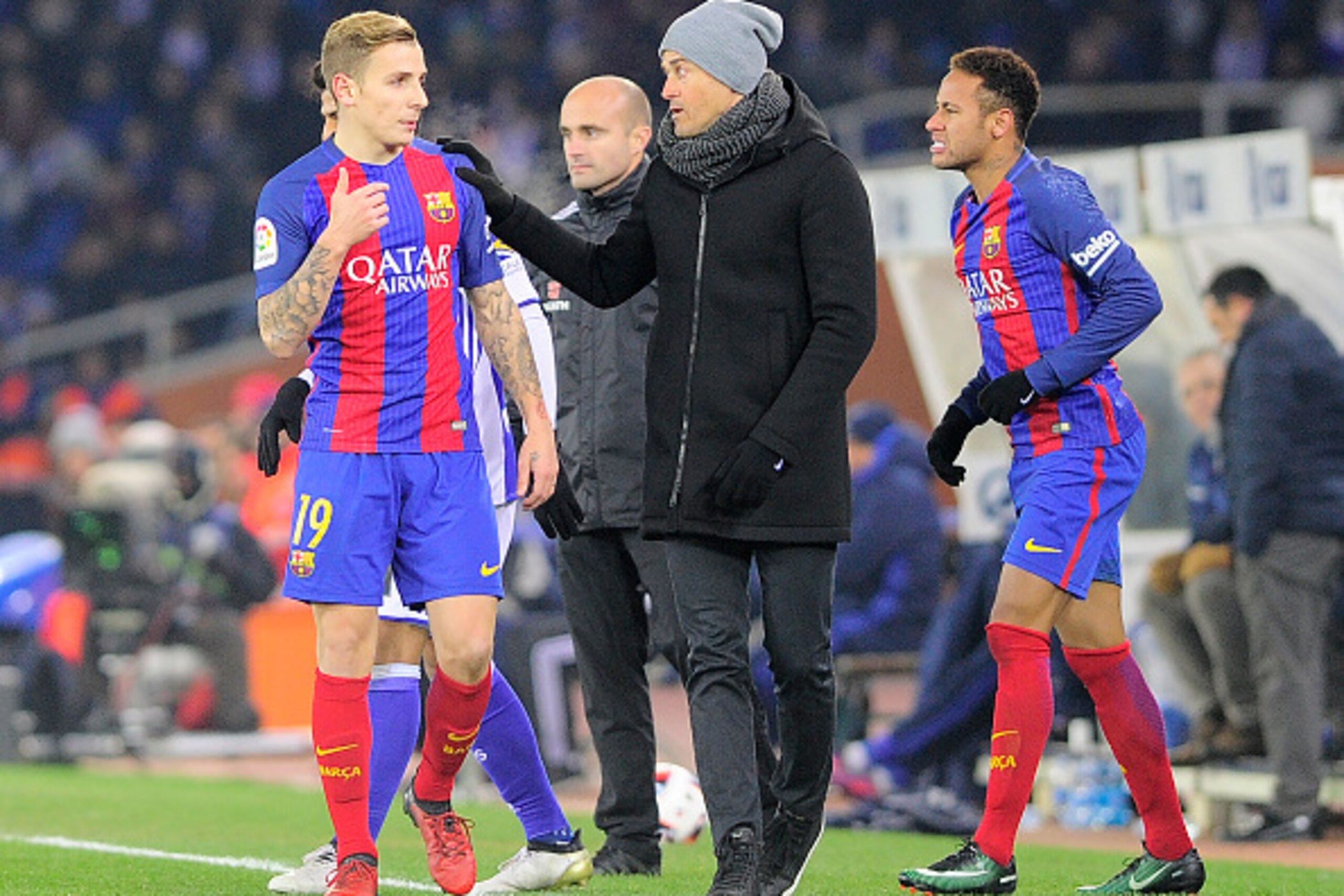Barcelona's French defender Lucas Digne (L) speaks with coach Luis Enrique during the Spanish Copa del Rey (King's Cup) quarter final first leg football match Real Sociedad vs FC Barcelona at the Anoeta stadium in San Sebastian on January 19, 2017. / AFP 