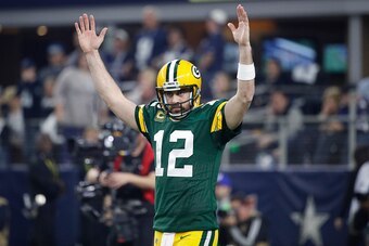 ARLINGTON, TX - JANUARY 15: Aaron Rodgers #12 of the Green Bay Packers reacts after a touchdown during the NFC Divisional Playoff game against the Dallas Cowboys at AT&T Stadium on January 15, 2017 in Arlington, Texas. The Packers defeated the Cowboys 34-