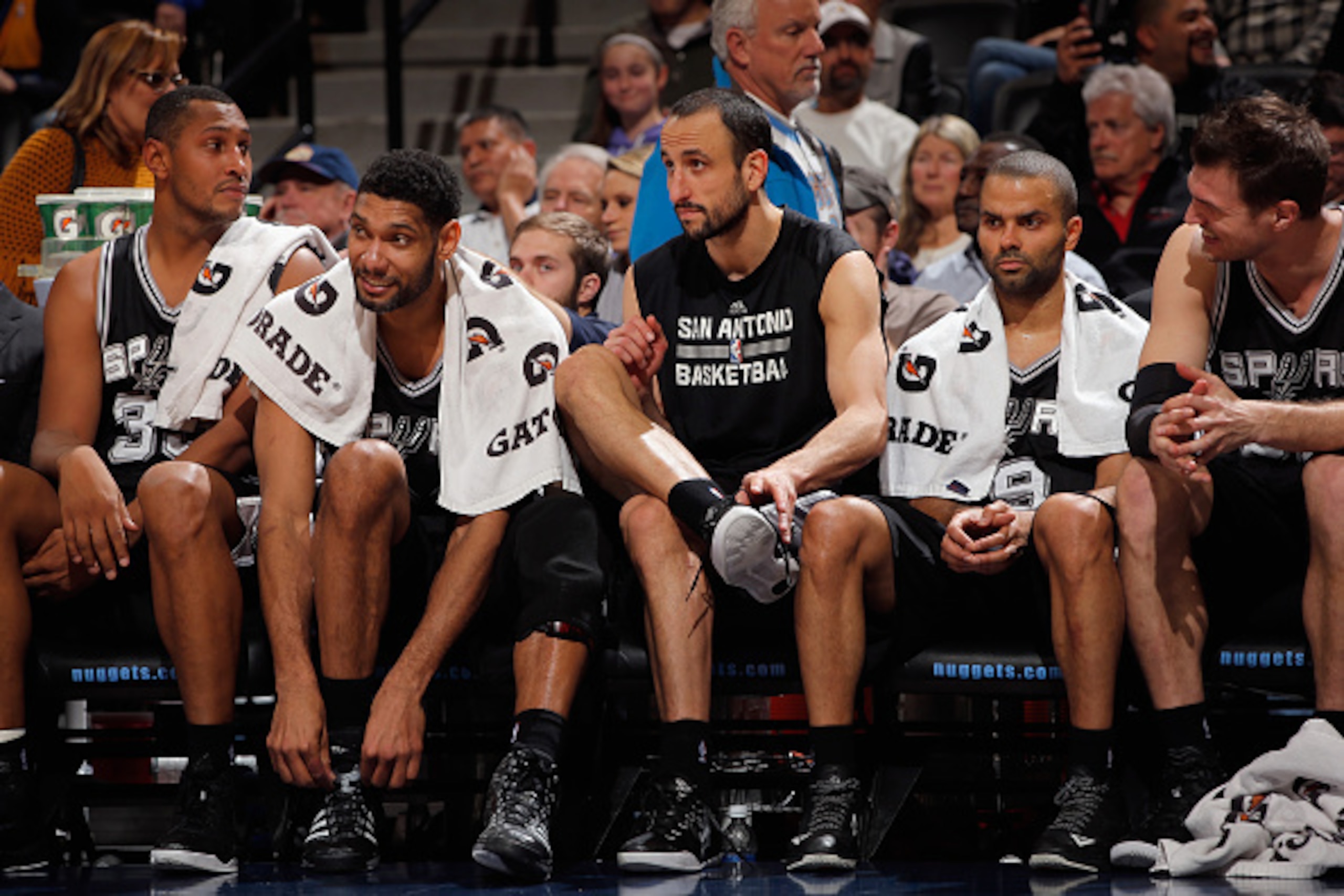 DENVER, CO - JANUARY 20:  (L-R) Boris Diaw #33, Tim Duncan #21, Manu Ginobili #20, Tony Parker #9 and Tiago Splitter #22 of the San Antonio Spurs sit on the bench late in the game against the Denver Nuggets at Pepsi Center on January 20, 2015 in Denver, C