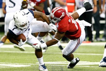 ATLANTA, GA - AUGUST 30:  Reuben Foster #10 of the Alabama Crimson Tide tackles Rushel Shell #7 of the West Virginia Mountaineers at Georgia Dome on August 30, 2014 in Atlanta, Georgia.  (Photo by Kevin C. Cox/Getty Images)