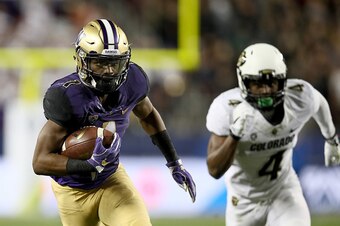 SANTA CLARA, CA - DECEMBER 02:  John Ross #1 of the Washington Huskies gets past Chidobe Awuzie #4 of the Colorado Buffaloes on his way to scoring a touchdown during the Pac-12 Championship game at Levi's Stadium on December 2, 2016 in Santa Clara, Califo