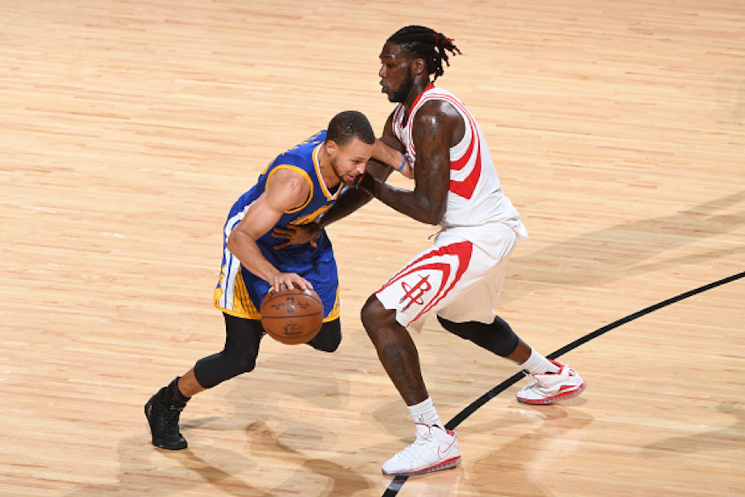 HOUSTON, TX - JANUARY 20:  Stephen Curry #30 of the Golden State Warriors drives to the basket against Montrezl Harrell #5 of the Houston Rockets during the game on January 20, 2017 at the Toyota Center in Houston, Texas. NOTE TO USER: User expressly ackn
