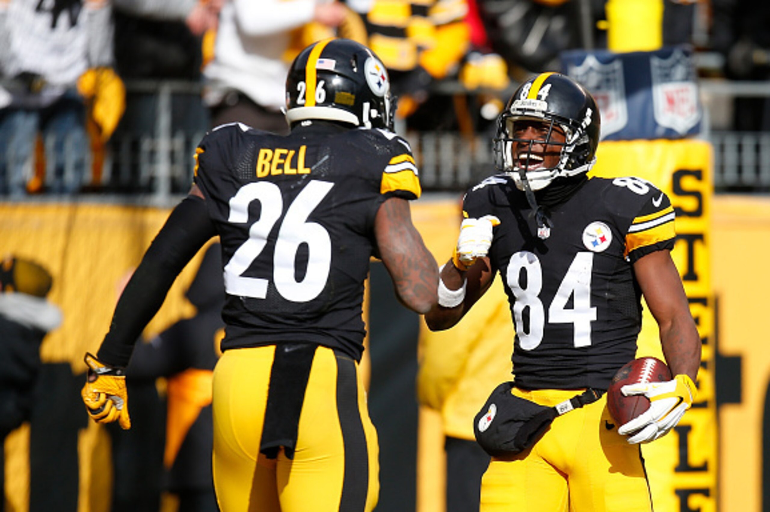 PITTSBURGH, PA - JANUARY 08:  Antonio Brown #84 of the Pittsburgh Steelers celebrates his touchdown with Le'Veon Bell #26 in the first quarter during the Wild Card Playoff game against the Miami Dolphins at Heinz Field on January 8, 2017 in Pittsburgh, Pe