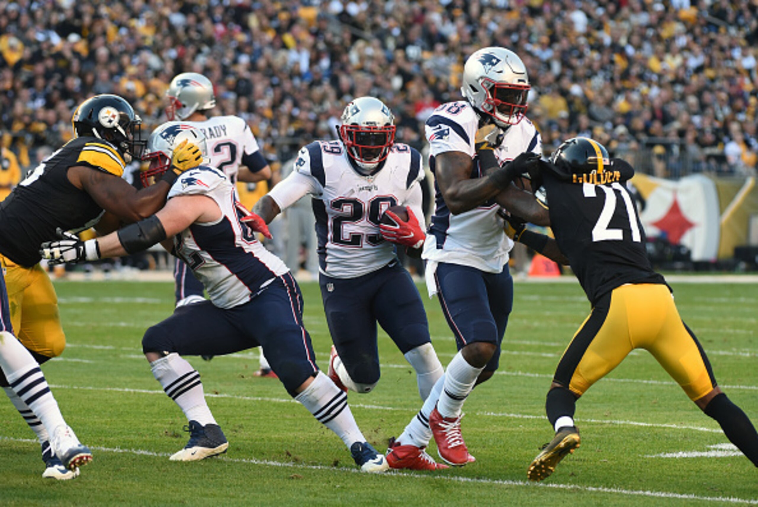 PITTSBURGH, PA - OCTOBER 23: Running back LeGarrette Blount #29 of the New England Patriots runs with the football as offensive lineman Joe Thuney #62 blocks defensive lineman L.T. Walton #96 of the Pittsburgh Steelers and tight end Martellus Bennett #88 