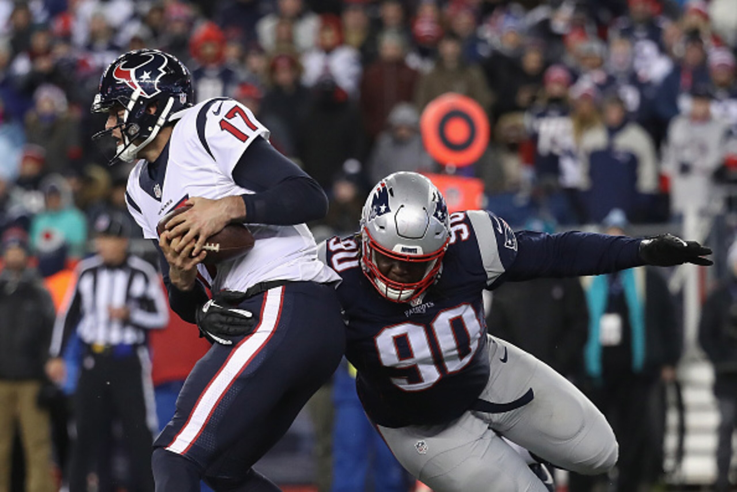 FOXBORO, MA - JANUARY 14:  Brock Osweiler #17 of the Houston Texans is tackled by Malcom Brown #90 of the New England Patriots in the second half during the AFC Divisional Playoff Game at Gillette Stadium on January 14, 2017 in Foxboro, Massachusetts.  (P