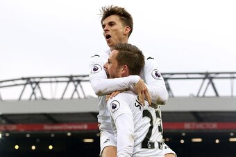 LIVERPOOL, ENGLAND - JANUARY 21: Tom Carroll and Gylfi Sigurosson of Swansea City celebrate scoring his sides third goal of the match during the Premier League match between Liverpool and Swansea City at Anfield on January 21, 2017 in Liverpool, England. 