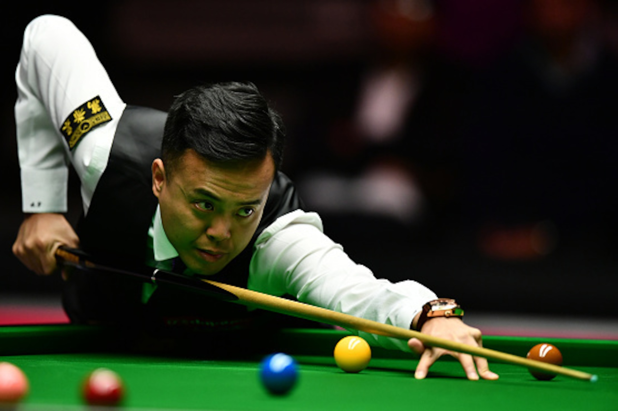 LONDON, ENGLAND - JANUARY 21:  Marco Fu of Hong Kong plays a shot during his semi final match against Ronnie O'Sullivan of England on day seven of the Dafabet Masters at Alexandra Palace on January 21, 2017 in London, England. (Photo by Dan Mullan/Getty I