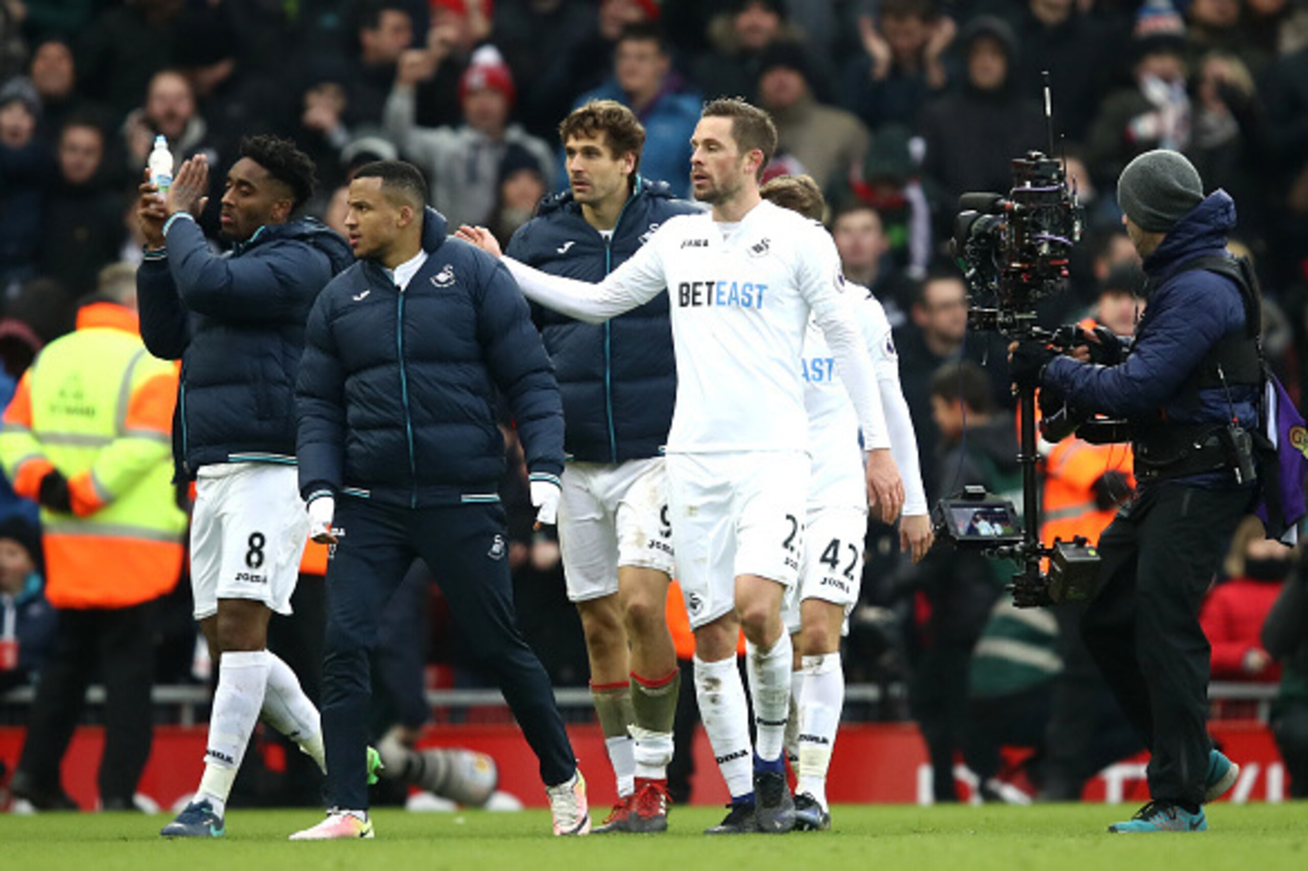 LIVERPOOL, ENGLAND - JANUARY 21: Gylfi Sigurdsson of Swansea City (R) and Martin Olsson of Swansea City (C) celebrate together after the Premier League match between Liverpool and Swansea City at Anfield on January 21, 2017 in Liverpool, England.  (Photo 
