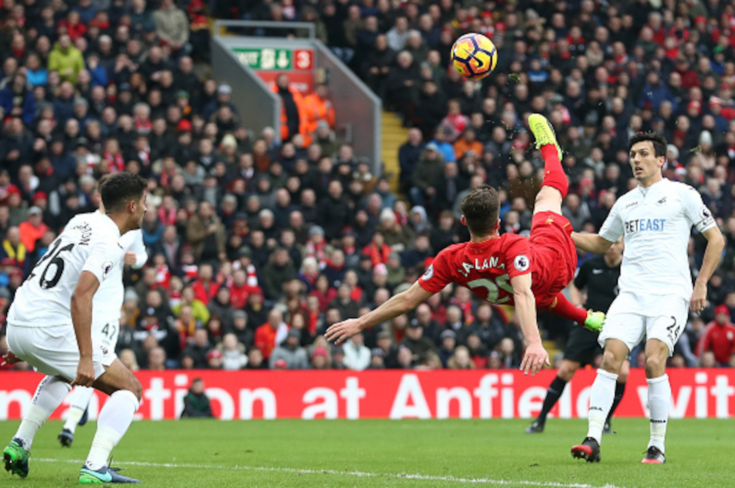 LIVERPOOL, ENGLAND - JANUARY 21: Adam Lallana of Liverpool (R) attempts a overhead kick during the Premier League match between Liverpool and Swansea City at Anfield on January 21, 2017 in Liverpool, England.  (Photo by Julian Finney/Getty Images)