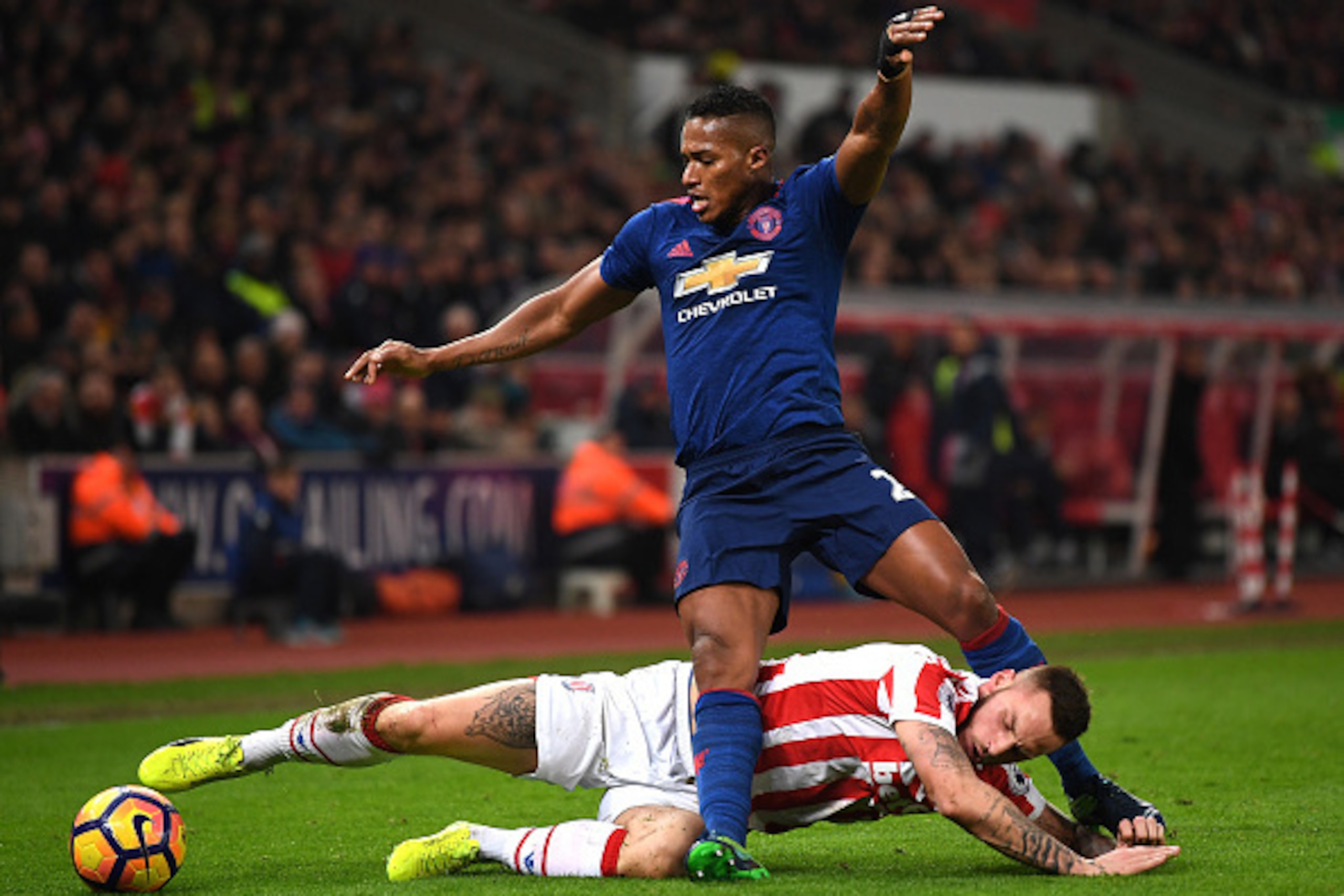 STOKE ON TRENT, ENGLAND - JANUARY 21:  Marko Arnautovic of Stoke City (R) tackles Antonio Valencia of Manchester United (L) during the Premier League match between Stoke City and Manchester United at Bet365 Stadium on January 21, 2017 in Stoke on Trent, E