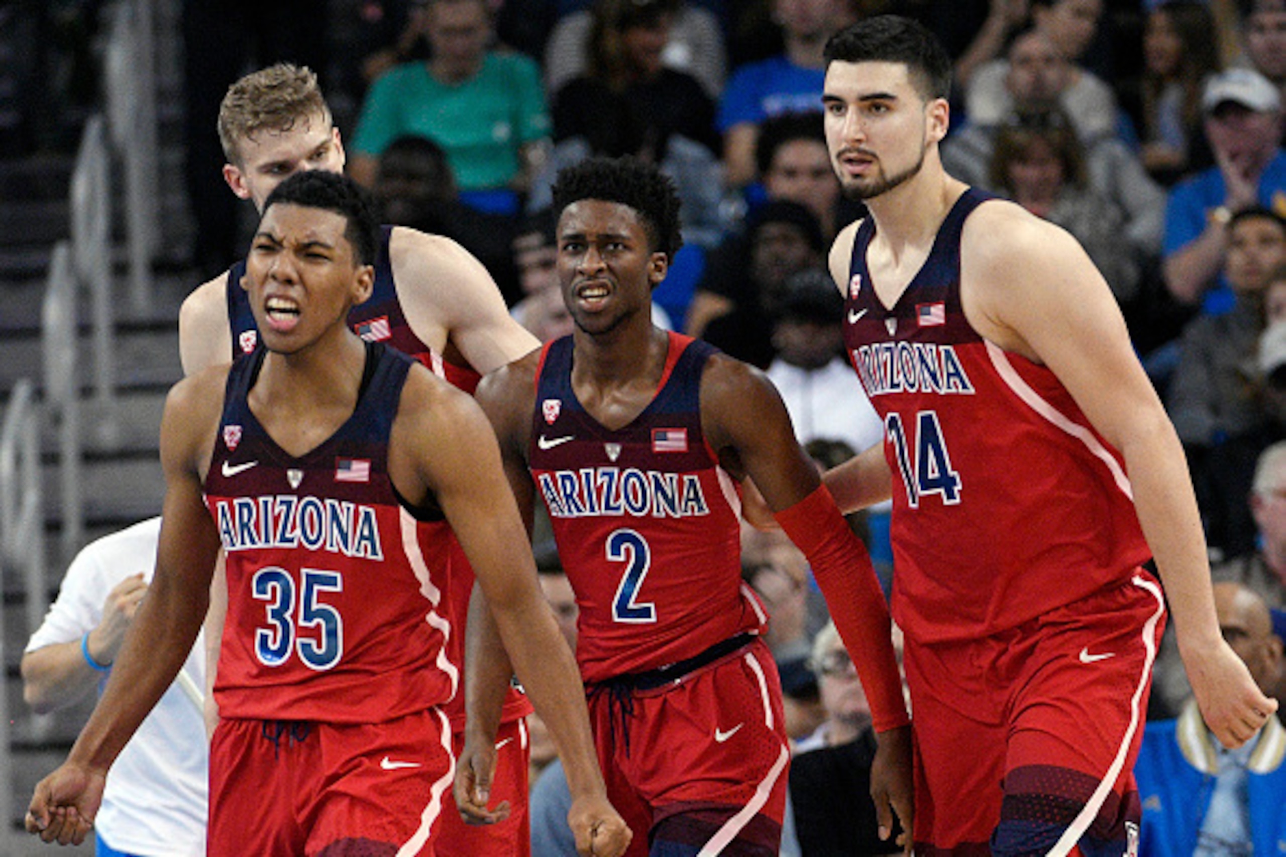 LOS ANGELES, CA - JANUARY 21: Kobi Simmons #2 of the Arizona Wildcats is congratulated by his teammates Dusan Ristic #14 and Allonzo Trier #35 after he scored a basket against UCLA during the second half of the game at Pauley Pavilion on January 21, 2017 