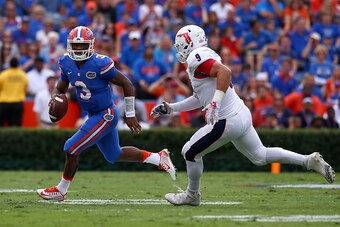 GAINESVILLE, FL - NOVEMBER 21: Treon Harris #3 of the Florida Gators is defende by Trey Hendrickson #9 of the Florida Atlantic Owls during the first half of the game at Ben Hill Griffin Stadium on November 21, 2015 in Gainesville, Florida.  (Photo by Rob 
