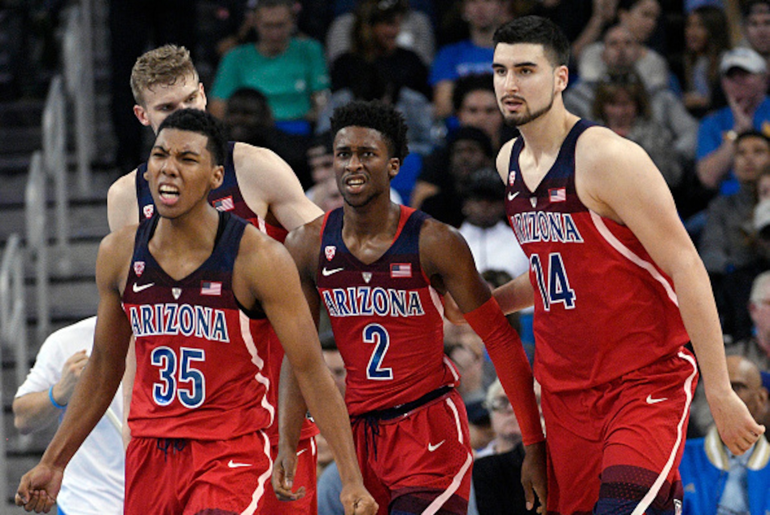 LOS ANGELES, CA - JANUARY 21: Kobi Simmons #2 of the Arizona Wildcats is congratulated by his teammates Dusan Ristic #14 and Allonzo Trier #35 after he scored a basket against UCLA during the second half of the game at Pauley Pavilion on January 21, 2017 