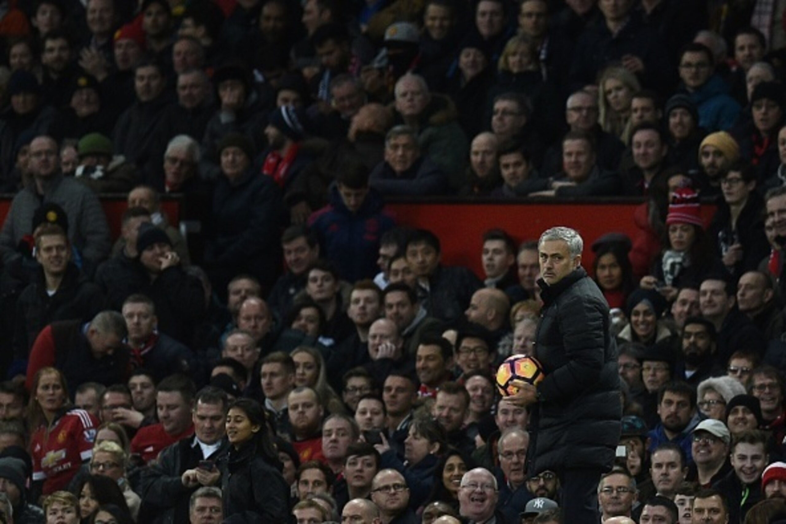 Manchester United's Portuguese manager Jose Mourinho gathers the ball during the English Premier League football match between Manchester United and Tottenham Hotspur at Old Trafford in Manchester, north west England, on December 11, 2016. / AFP / OLI SCA