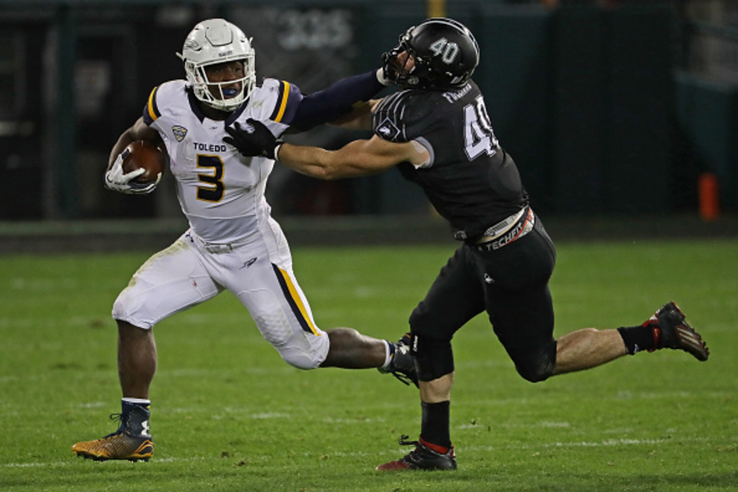 CHICAGO, IL - NOVEMBER 09:  Kareem Hunt #3 of the Toledo Rockets tries Toledo Rockets hold off Sean Folliard #40 of the Northern Illinois Huskies at Guaranteed Rate  Field, home of the Chicago White Sox, on November 9, 2016 in Chicago, Illinois.  (Photo b