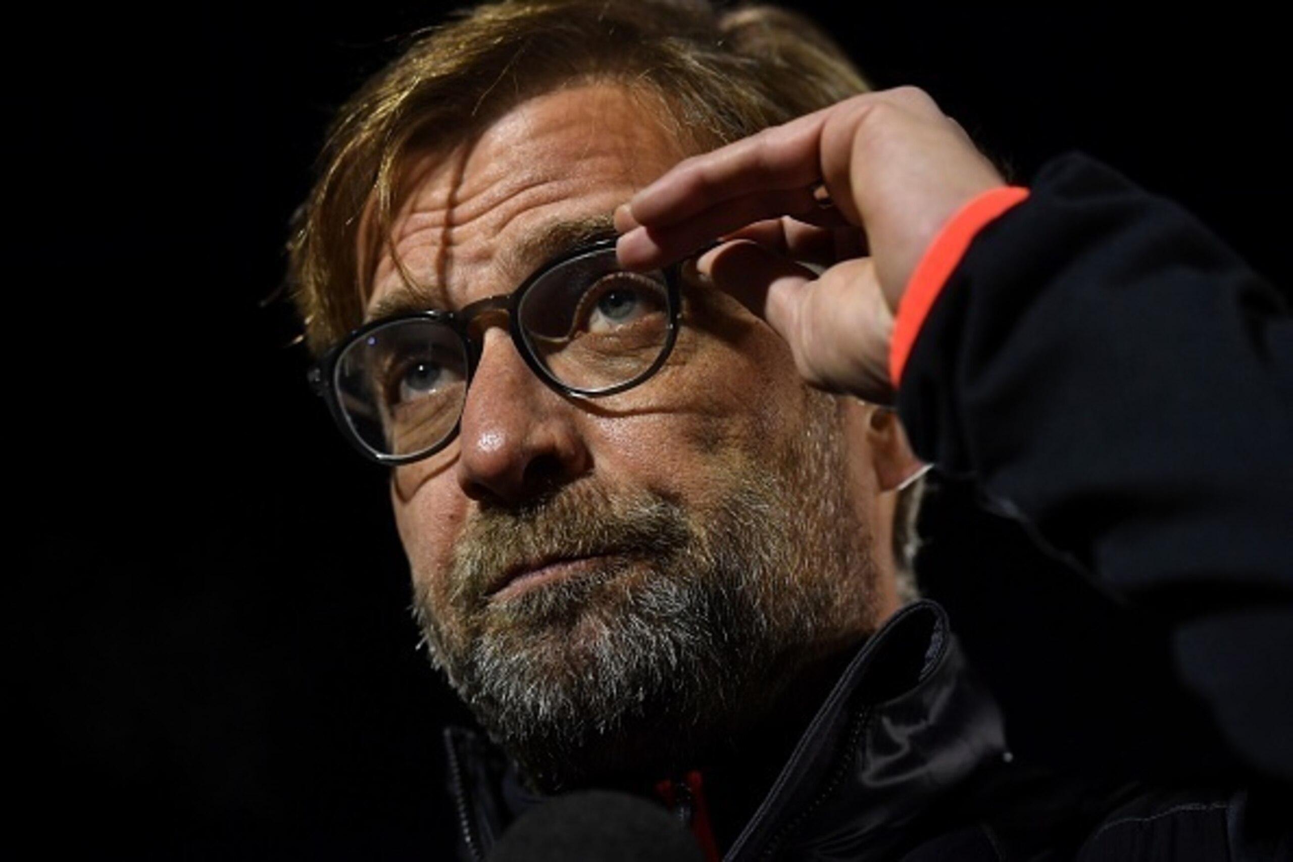 Liverpool's German manager Jurgen Klopp adjusts his glasses as he gives an interview ahead of the English FA Cup third round replay football match between Plymouth Argyle and Liverpool at Home Park in Plymouth, south west England on January 18, 2017. / AF