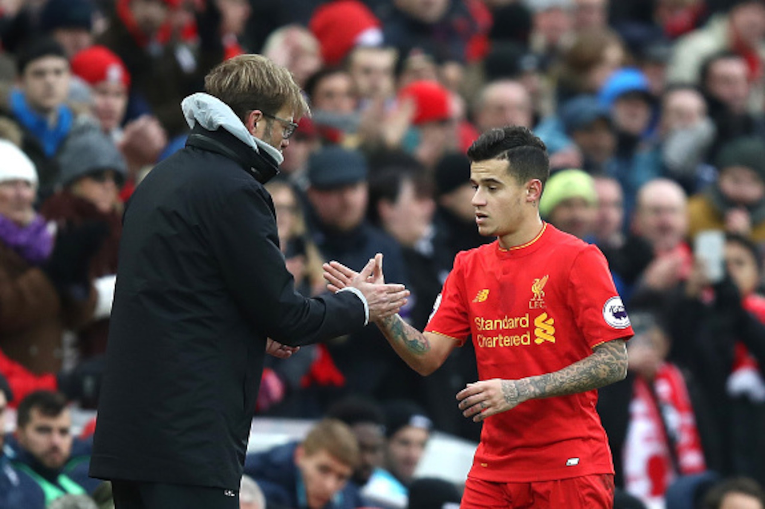 LIVERPOOL, ENGLAND - JANUARY 21: Jurgen Klopp, Manager of Liverpool (L) and Philippe Coutinho of Liverpool (R) shake hands after he is subbed off during the Premier League match between Liverpool and Swansea City at Anfield on January 21, 2017 in Liverpoo