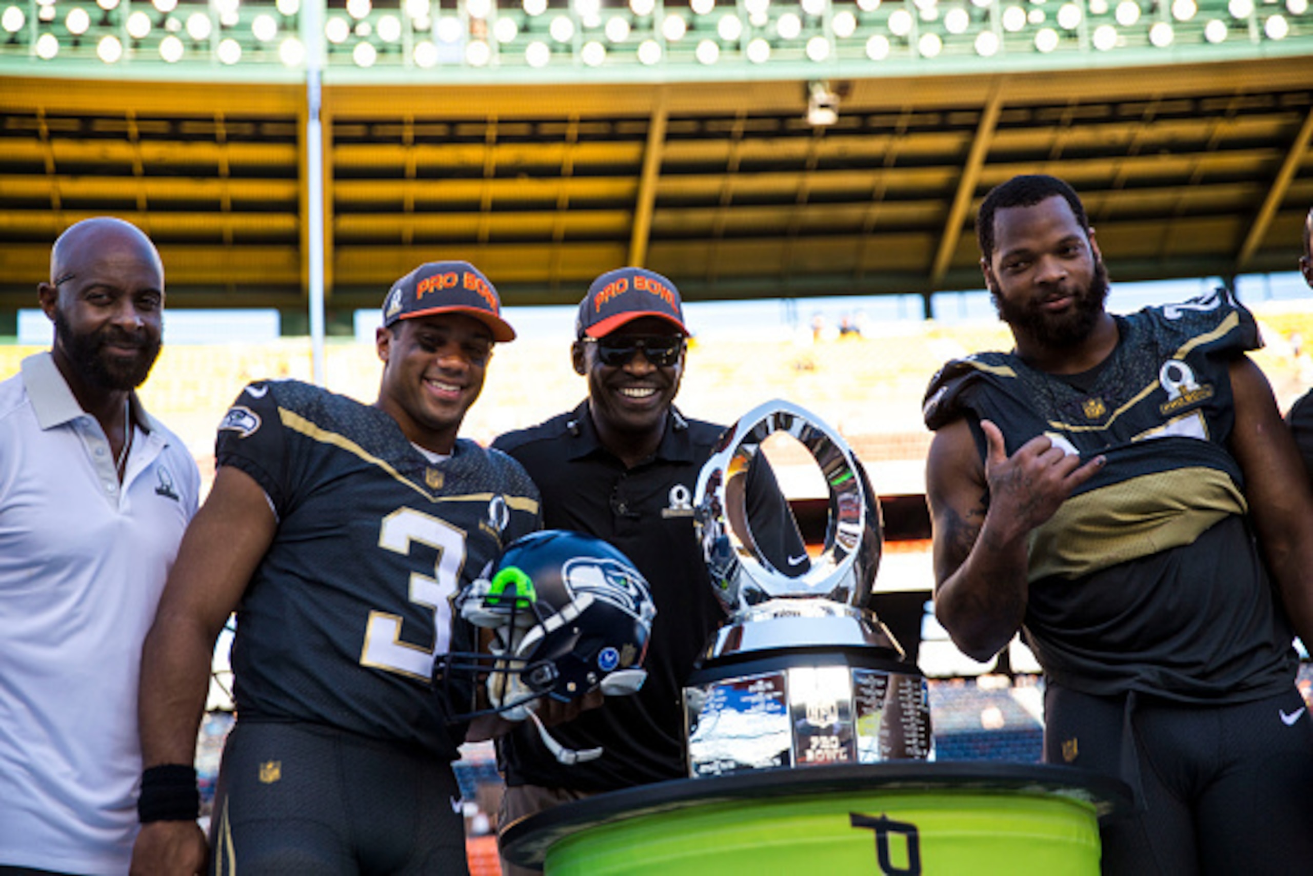 HONOLULU, HI -  SUNDAY, JANUARY 31:  Jerry Rice, Team Irvin quarterback Russell Wilson #3 of the Seattle Seahawks Michael Irvin, and defensive end Michael Bennett #72 of the Seattle Seahawks pose with the Pro Bowl Trophy after the end of the 2016 NFL Pro 