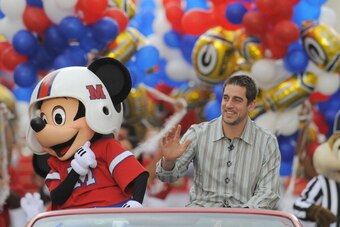 LAKE BUENA VISTA, FL - FEBRUARY 07:  In this handout photo provided by Disney, Super Bowl XLV Most Valuable Player Aaron Rodgers takes a celebratory ride with Mickey Mouse, following the Green Bay Packers' 31-25 victory over the Pittsburgh Steelers Februa