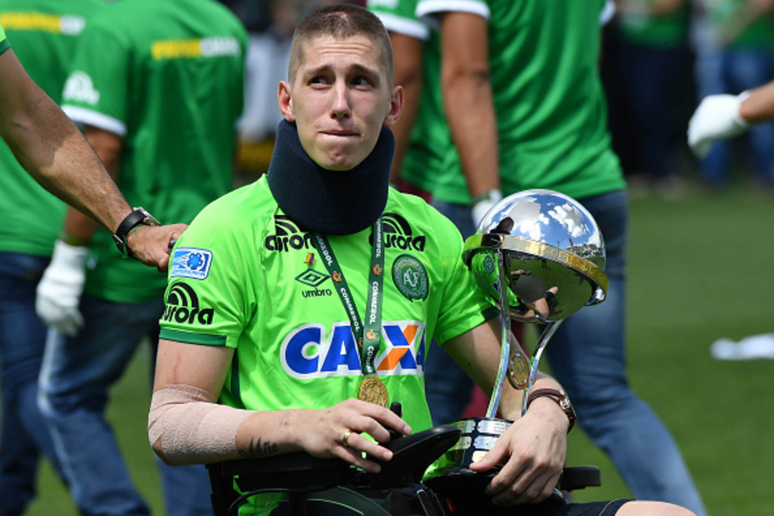 Brazilian Chapecoense goalkeeper Jackson Follmann, a survivor of the LaMia airplane crash in Colombia, holds the Copa Sudamericana trophy at the Arena Conda stadium in Chapeco, Santa Catarina state, in southern Brazil on January 21, 2017, before a friendl