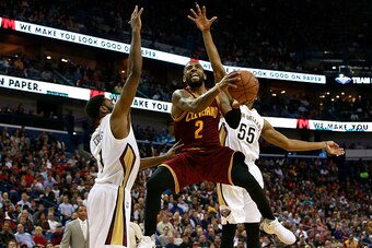 NEW ORLEANS, LA - JANUARY 23:  Kyrie Irving #2 of the Cleveland Cavaliers goes up for a shot against Tyreke Evans #1 and E'Twaun Moore #55 of the New Orleans Pelicans during the second half at the Smoothie King Center on January 23, 2017 in New Orleans, L