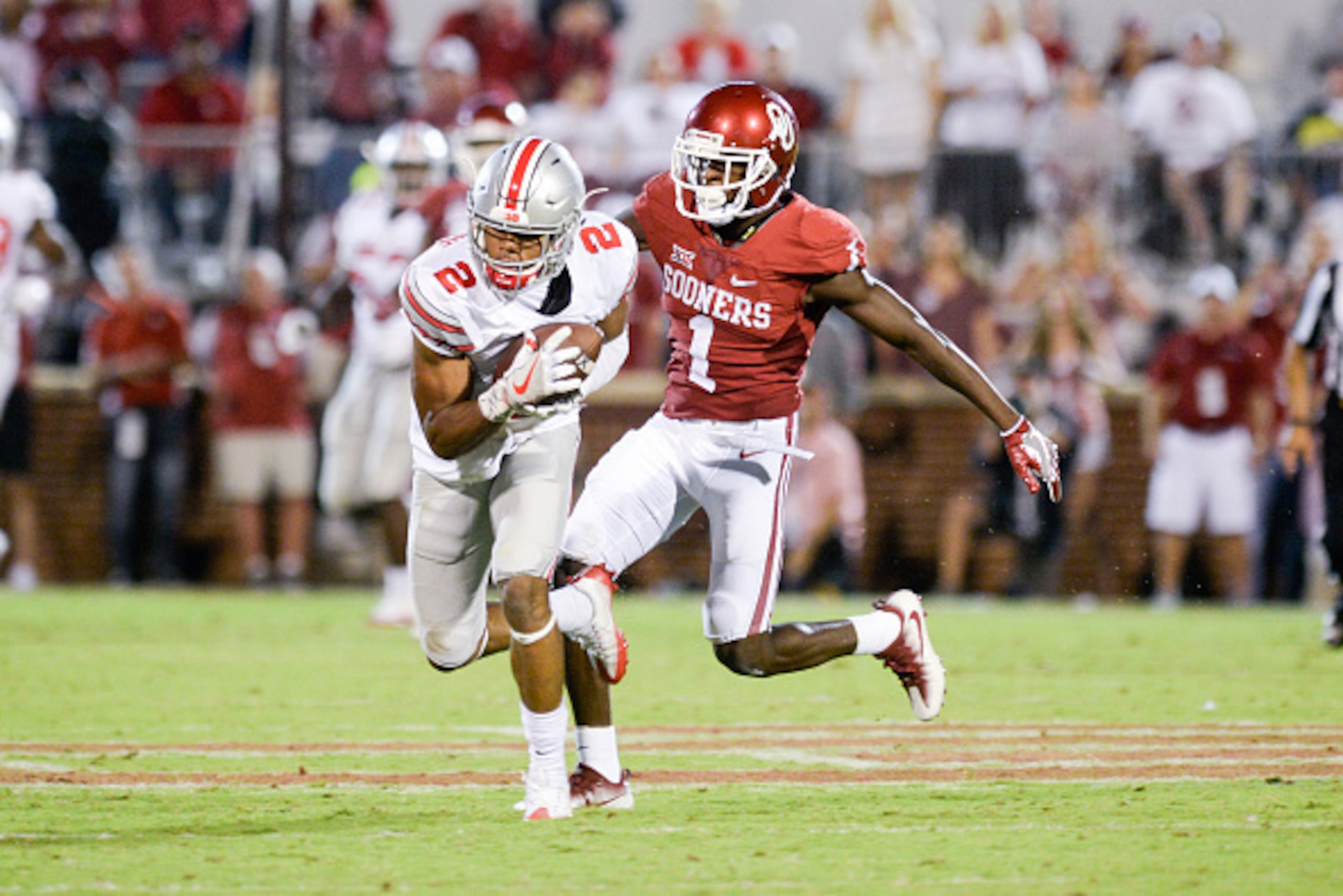 NORMAN, OK - SEPTEMBER 17: Marshon Lattimore #2 of the Ohio State Buckeyes intercepts a pass in front of Jarvis Baxter #1 of the Oklahoma Sooners at Gaylord Family Oklahoma Memorial Stadium on September 17, 2016 in Norman, Oklahoma. (Photo by Joshua Gatel