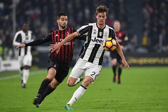 TURIN, ITALY - JANUARY 25:  Daniele Rugani (R) of Juventus FC is challenged by Fernandez Suso of AC Milan during the TIM Cup match between Juventus FC and AC Milan at Juventus Stadium on January 25, 2017 in Turin, Italy.  (Photo by Valerio Pennicino/Getty