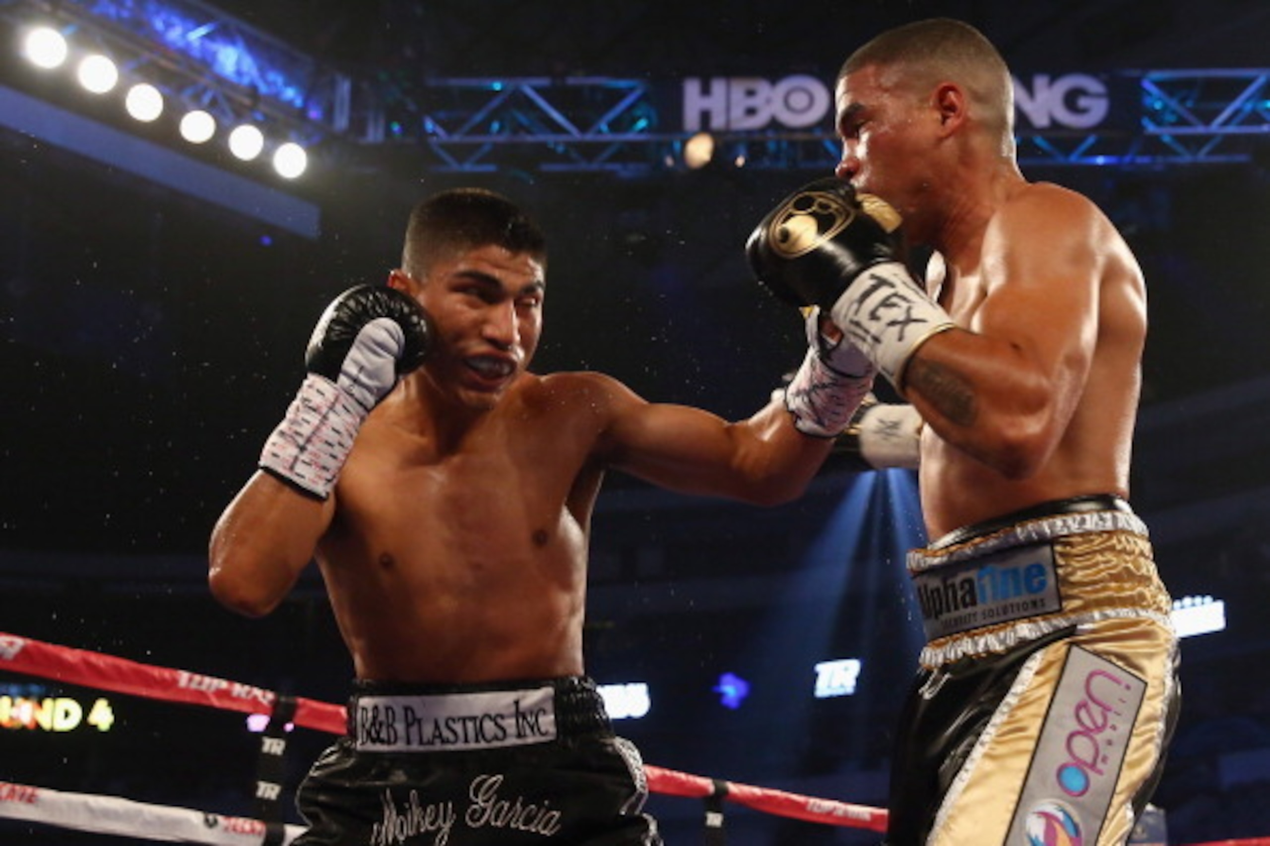 DALLAS, TX - JUNE 15:  (L-R) Mikey Garcia connects with a left to the face of Juan Manuel Lopez during their Vacant WBO Featherweight Title bout at American Airlines Center on June 15, 2013 in Dallas, Texas. Garcia knocked out Lopez in the fourth round.  