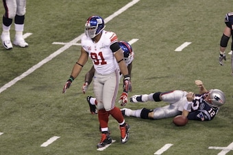 INDIANAPOLIS, IN - FEBRUARY 5: Justin Tuck #91 of the New York Giants sacks Tom Brady #12 of the New England Patriots during Super Bowl XLVI at Lucas Oil Stadium on February 5, 2012 in Indianapolis, Indiana. The Giants defeated the Patriots 21-17. (Photo 