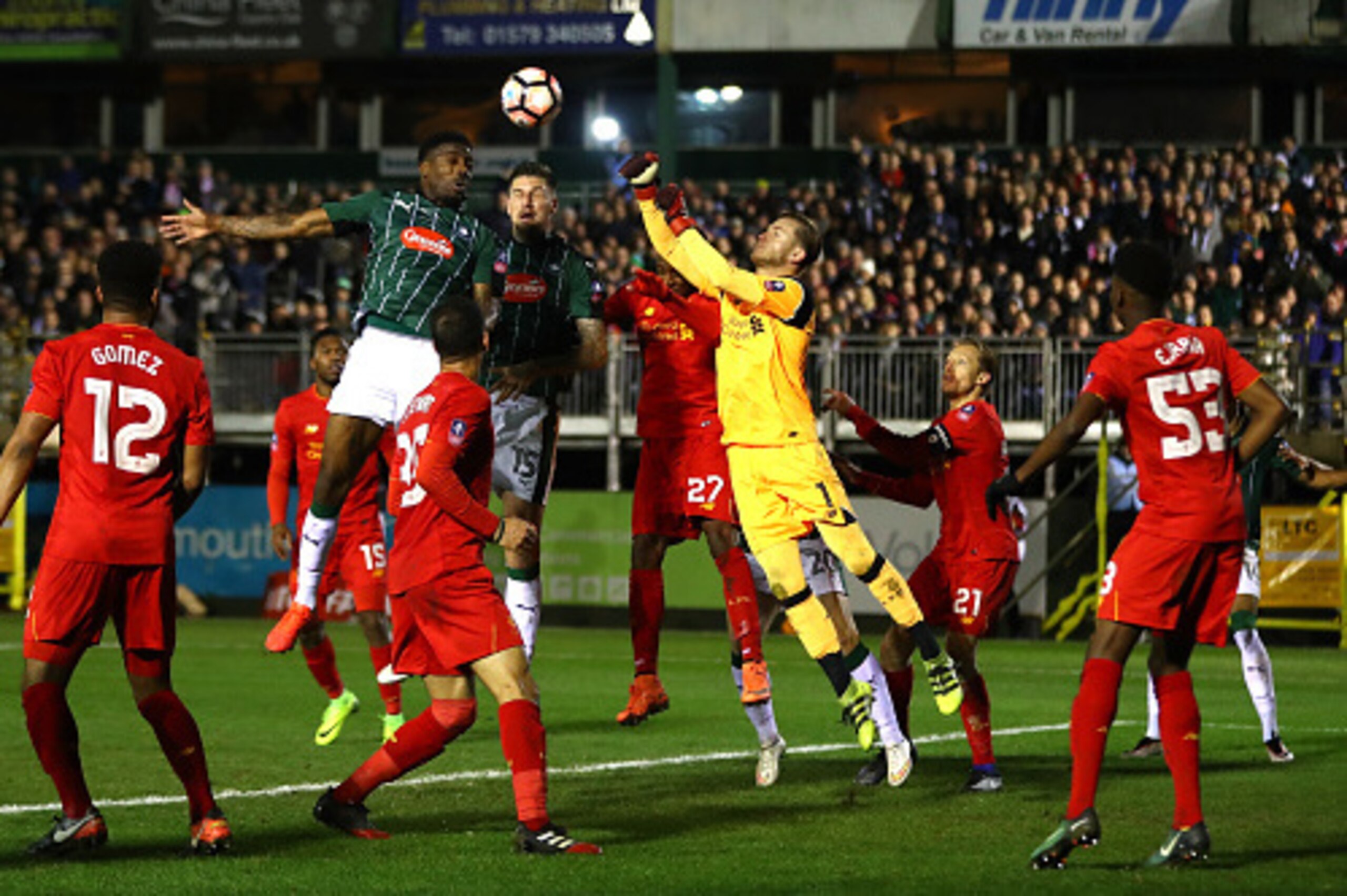 PLYMOUTH, ENGLAND - JANUARY 18: Loris Karius of Liverpool clears the ball as he is put under pressure from Sonny Bradley of Plymouth Argyle (15)  during The Emirates FA Cup Third Round Replay match between Plymouth Argyle and Liverpool at Home Park on Jan