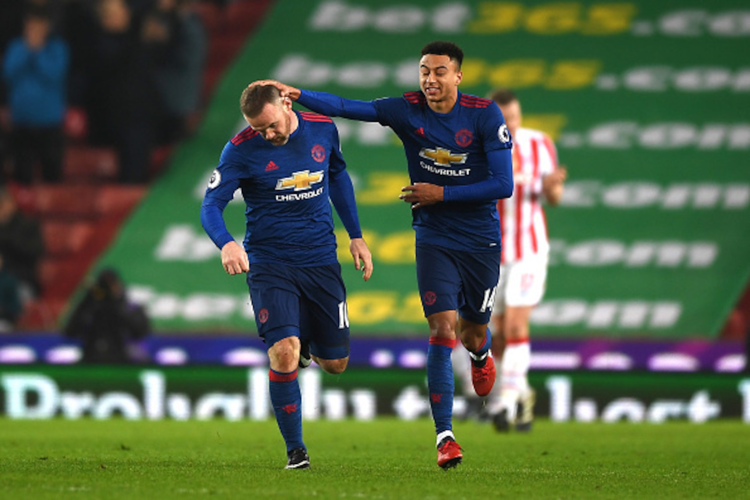 STOKE ON TRENT, ENGLAND - JANUARY 21:  Wayne Rooney of Manchester United (L) celebrates scoring his sides first goal with Jesse Lingard of Manchester United (R) during the Premier League match between Stoke City and Manchester United at Bet365 Stadium on 