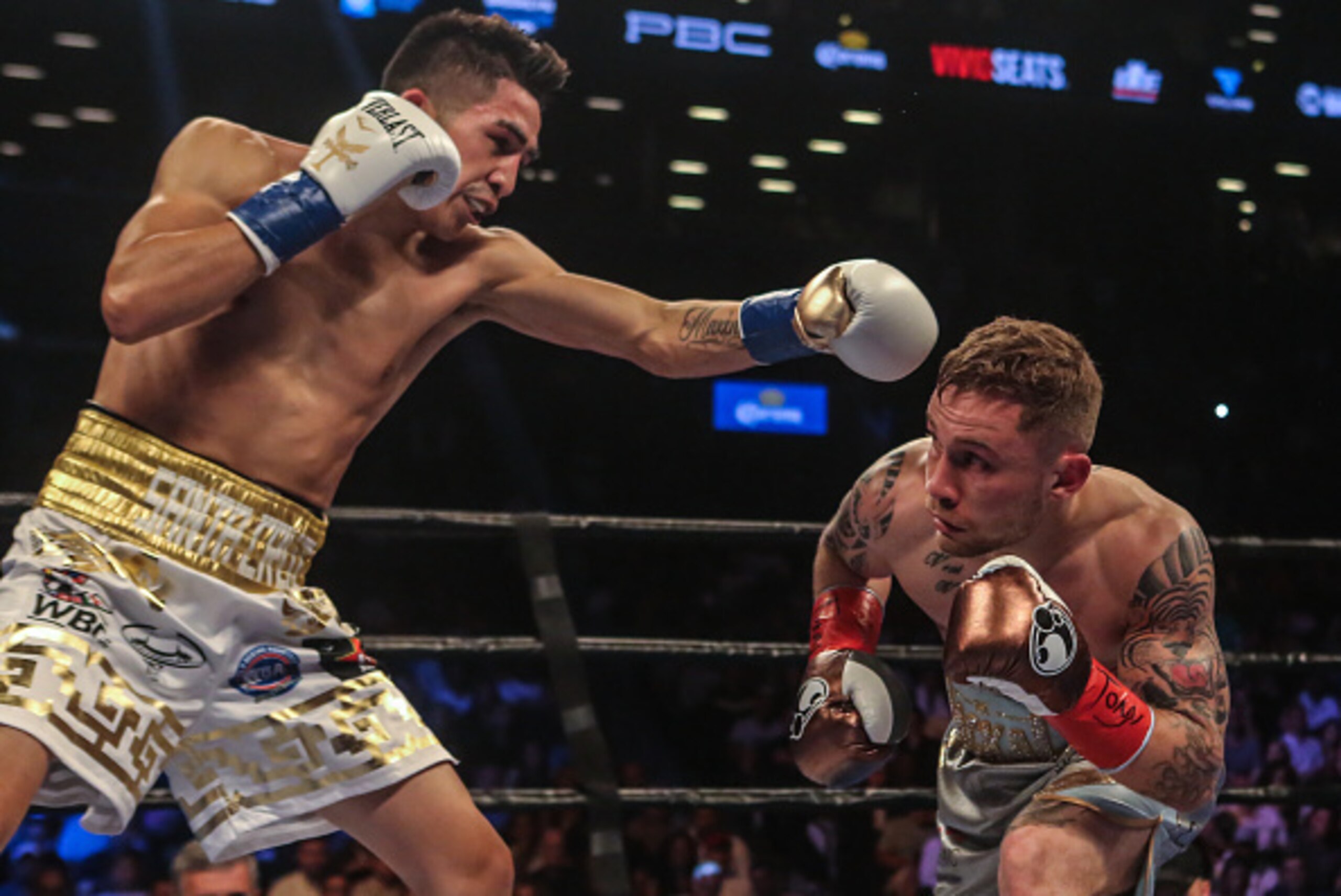NEW YORK, NY - JULY 30: Leo Santa Cruz of Mexico (gold trunks) fights Carl Frampton of Northern Ireland (blue trunks) during their 12 round WBA Super featherweight championship bout at Barclays Center on July 30, 2016 in the Brooklyn borough in New York C