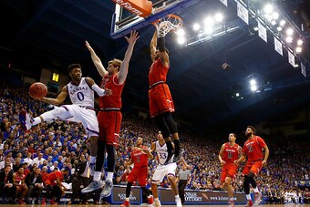 LAWRENCE, KS - JANUARY 07:  Frank Mason III #0 of the Kansas Jayhawks looks to pass as Matthew Temple #34 and Justin Gray #5 of the Texas Tech Red Raiders defend during the game at Allen Fieldhouse on January 7, 2017 in Lawrence, Kansas.  (Photo by Jamie 
